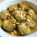 Alcachofas en Salsa con Piñones